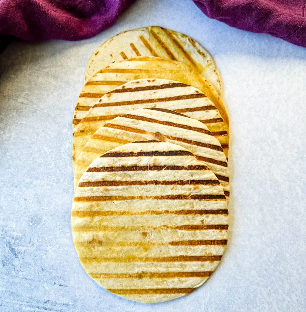 seared flour tortillas on a flat surface