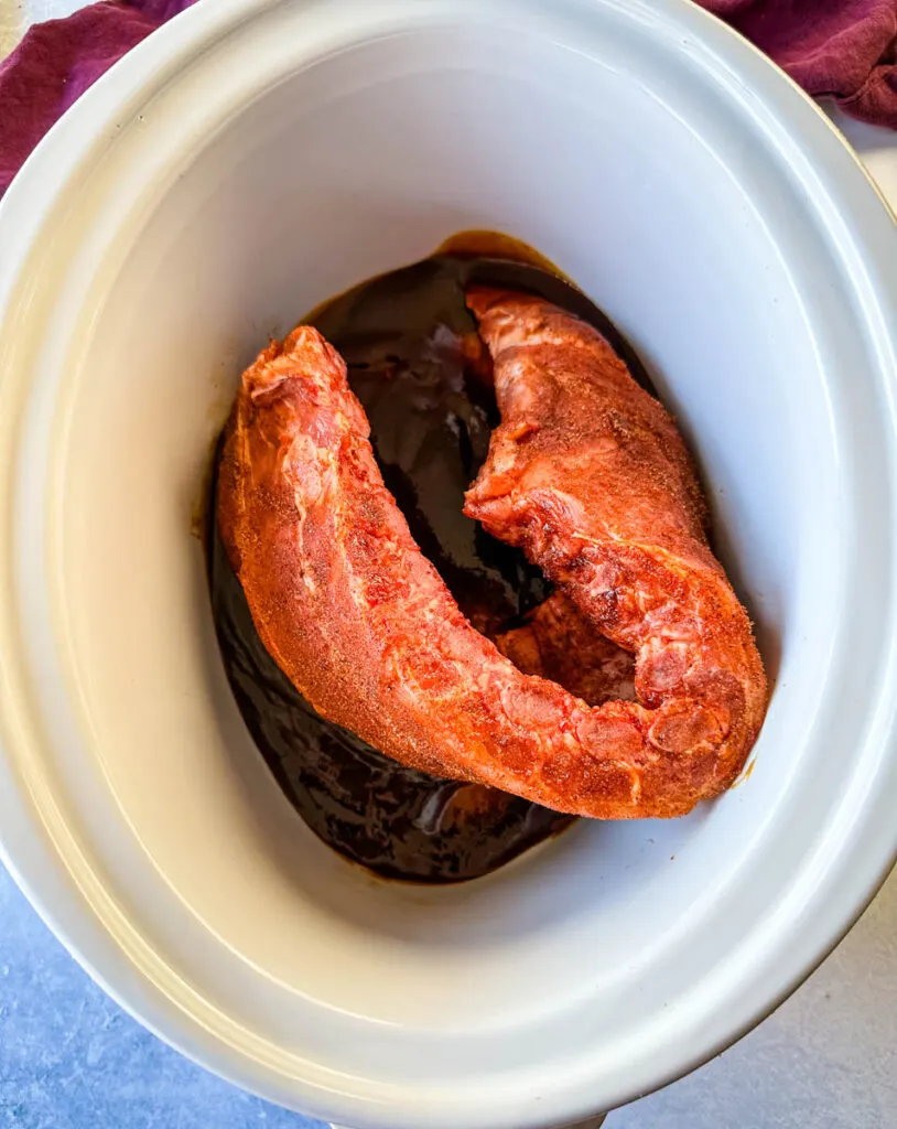 ribs in a Crockpot slow cooker with BBQ sauce