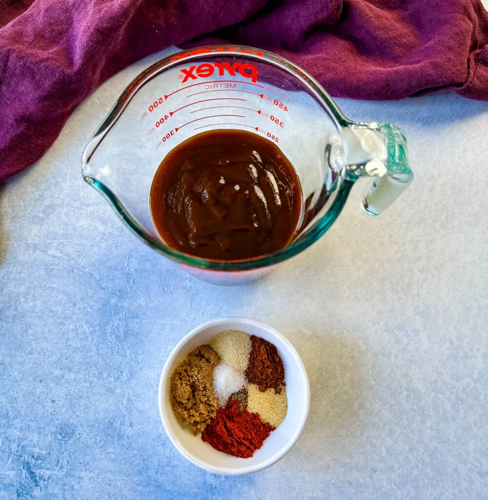 homemade BBQ rub and BBQ sauce in separate bowls