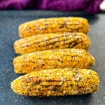 Traeger smoked corn on the cob with garlic butter on a sheet pan