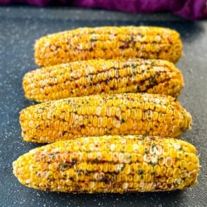 Traeger smoked corn on the cob with garlic butter on a sheet pan