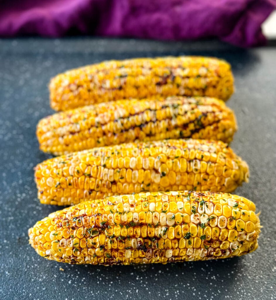 Traeger smoked corn on the cob with garlic butter on a sheet pan