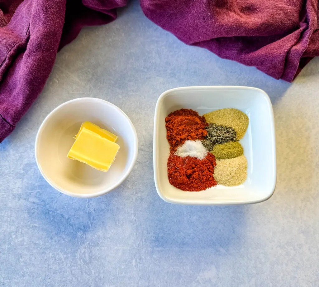 butter and blackening spices in separate white bowls