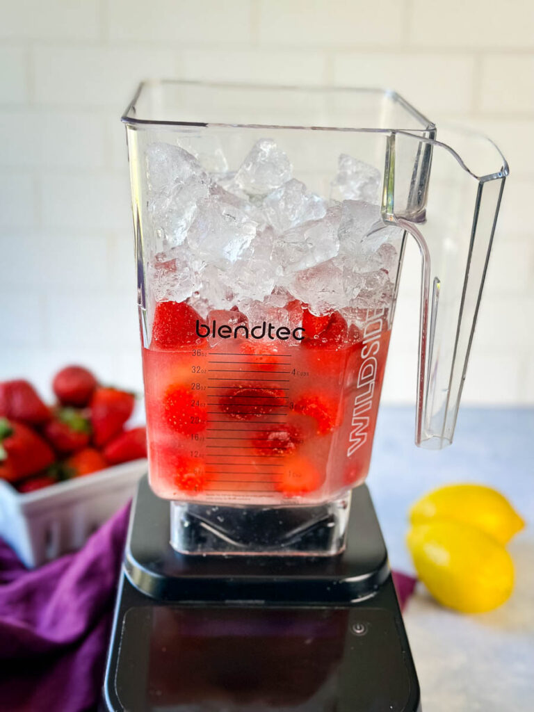 frozen strawberries and ice in a blender