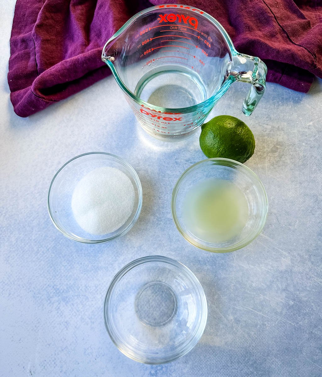 water, sweetener or sugar, fresh lime juice, and tequila in separate glass bowls