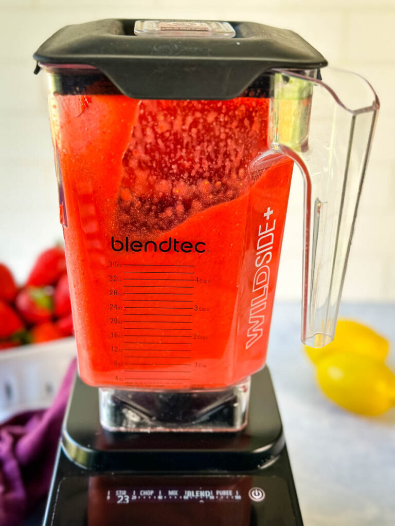 fresh cut strawberries in a blender