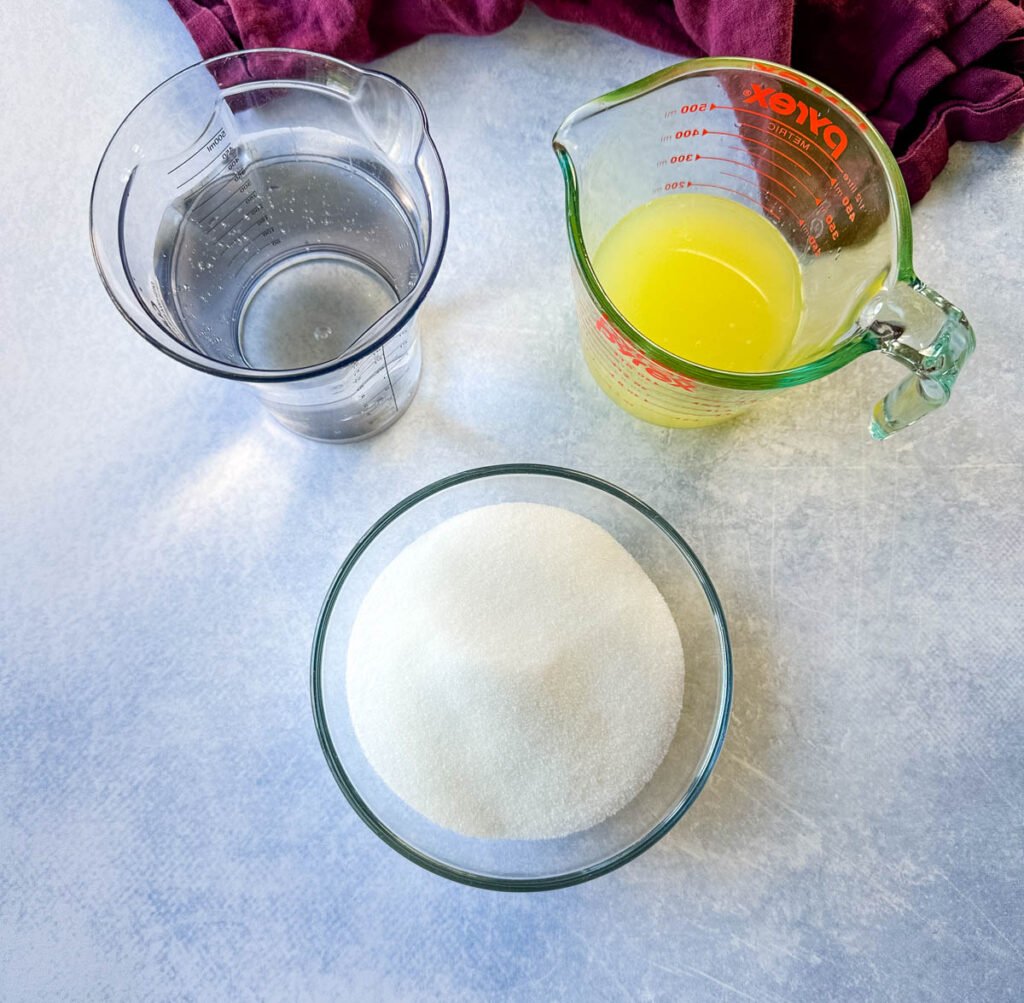 water, fresh lemon juice, and sweetener in separate glass bowls and cups
