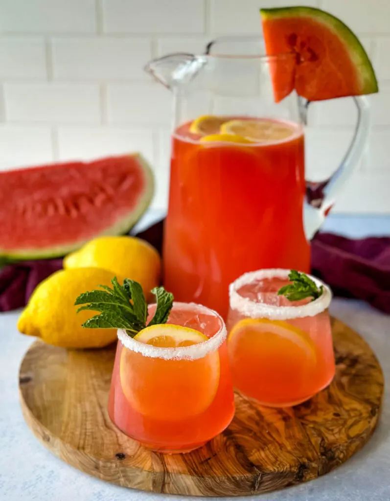 watermelon lemonade in glasses and a pitcher with fresh watermelon and lemons