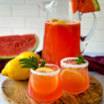 watermelon lemonade in glasses and a pitcher with fresh watermelon and lemons