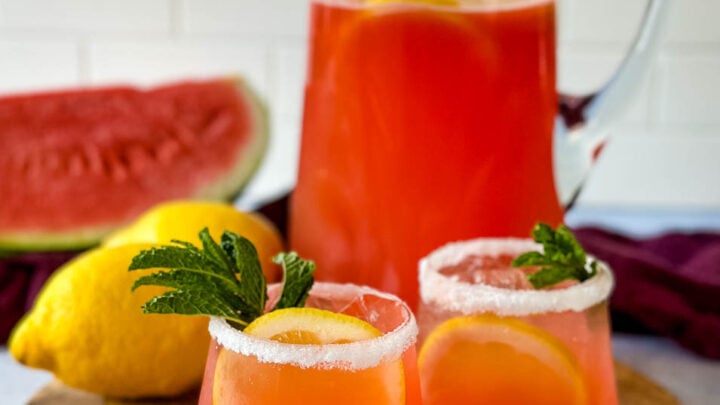 watermelon lemonade in glasses and a pitcher with fresh watermelon and lemons