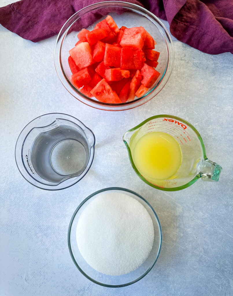 cubed fresh watermelon, fresh lemon juice, sweetener or sugar, and water in separate glass bowls
