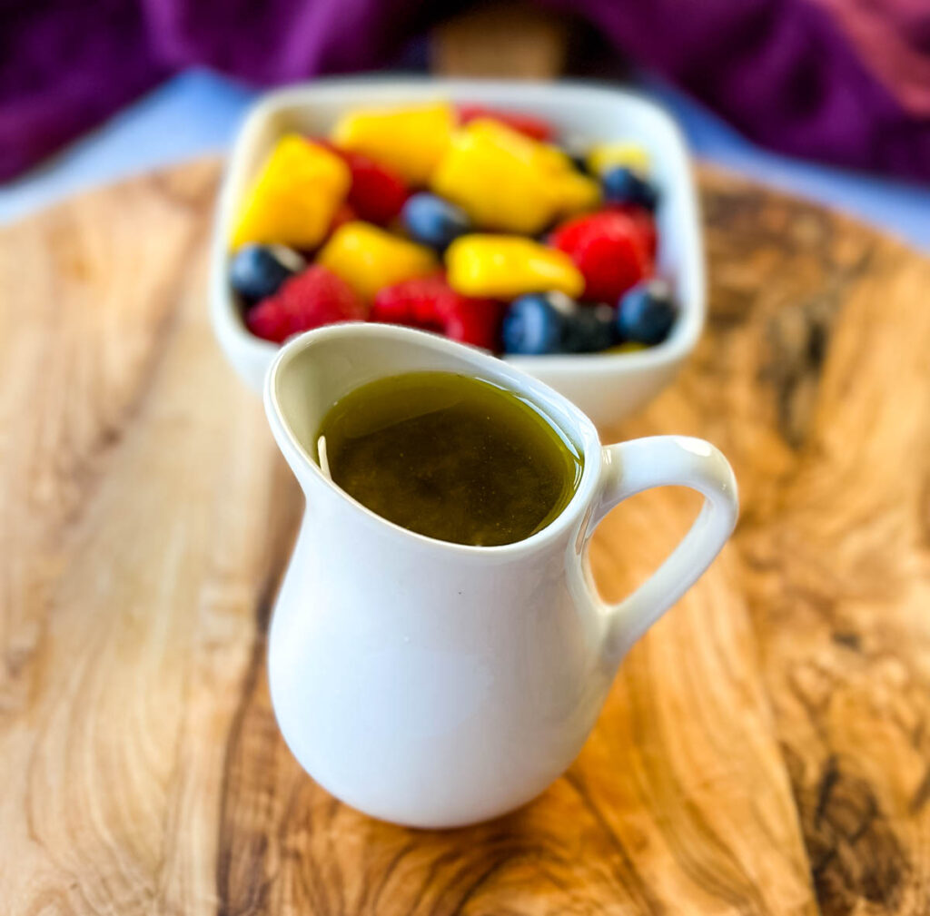 honey lime dressing and fresh fruit on a cutting board