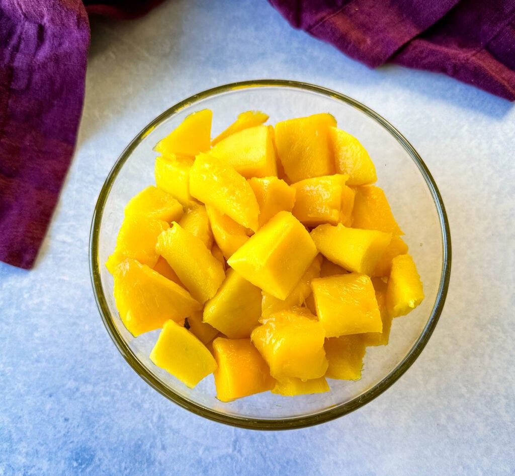 fresh mango chunks in a glass bowl