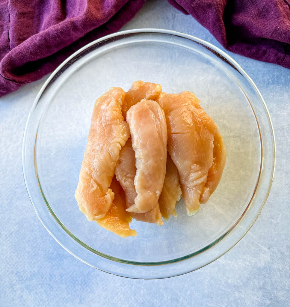 raw chicken tenders in a glass bowl