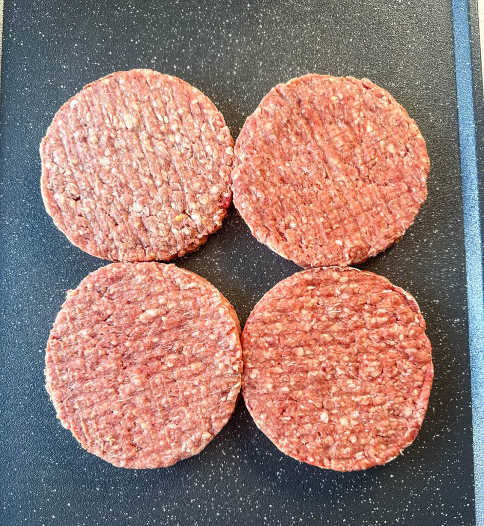 raw burgers on a flat surface