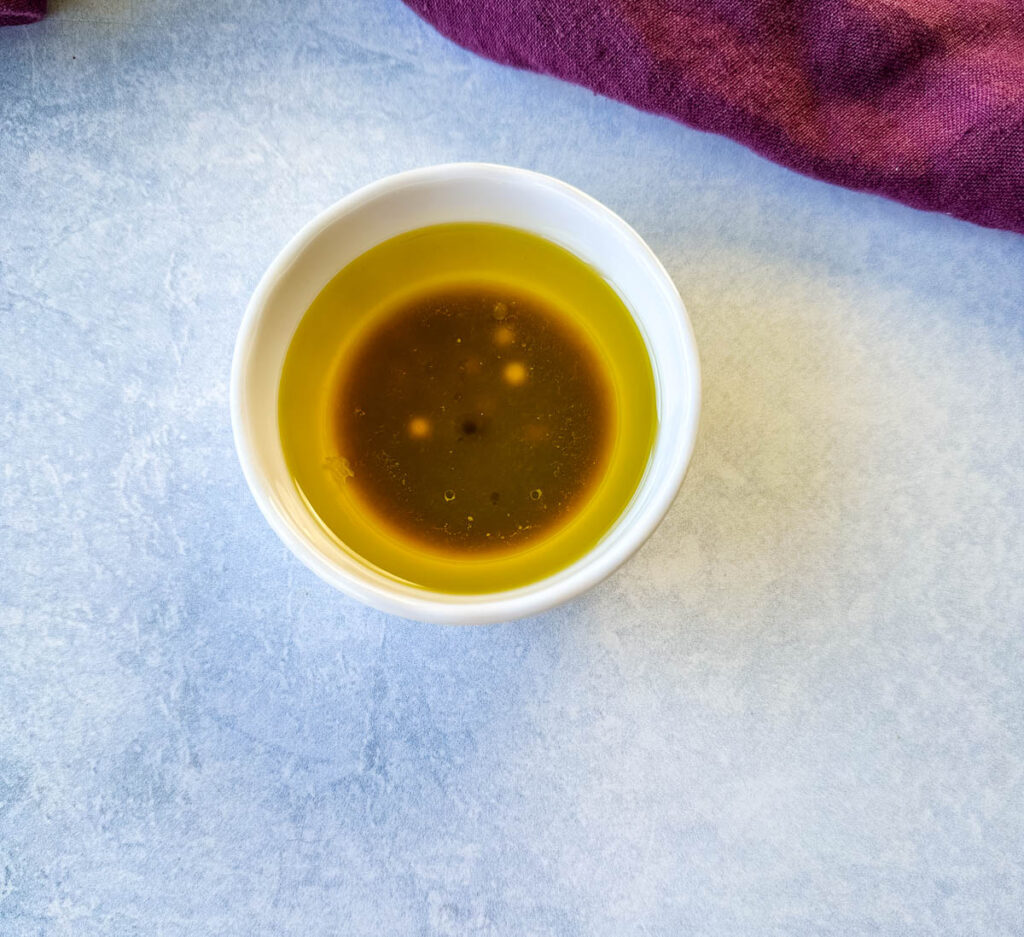 olive oil, balsamic vinegar, and lime juice in a white bowl