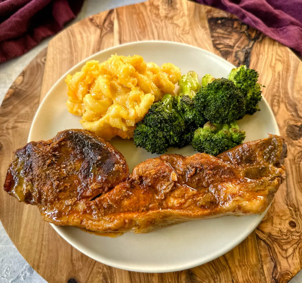 country style ribs on a plate with mac and cheese and collard greens
