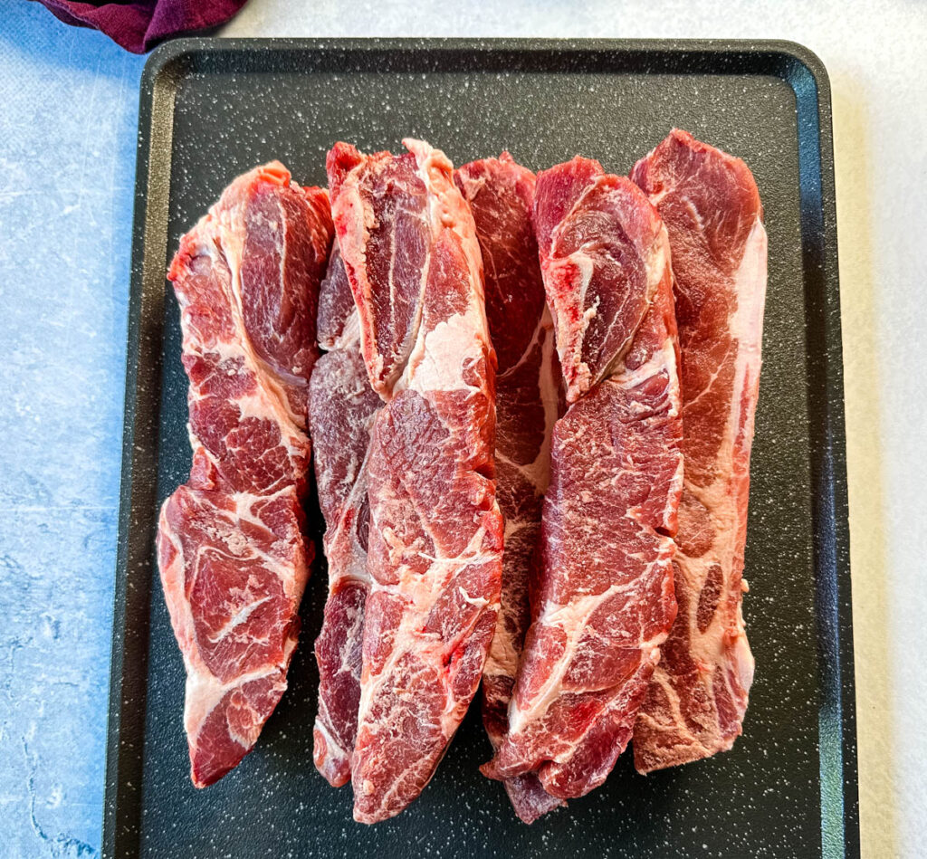raw country style ribs on a sheet pan