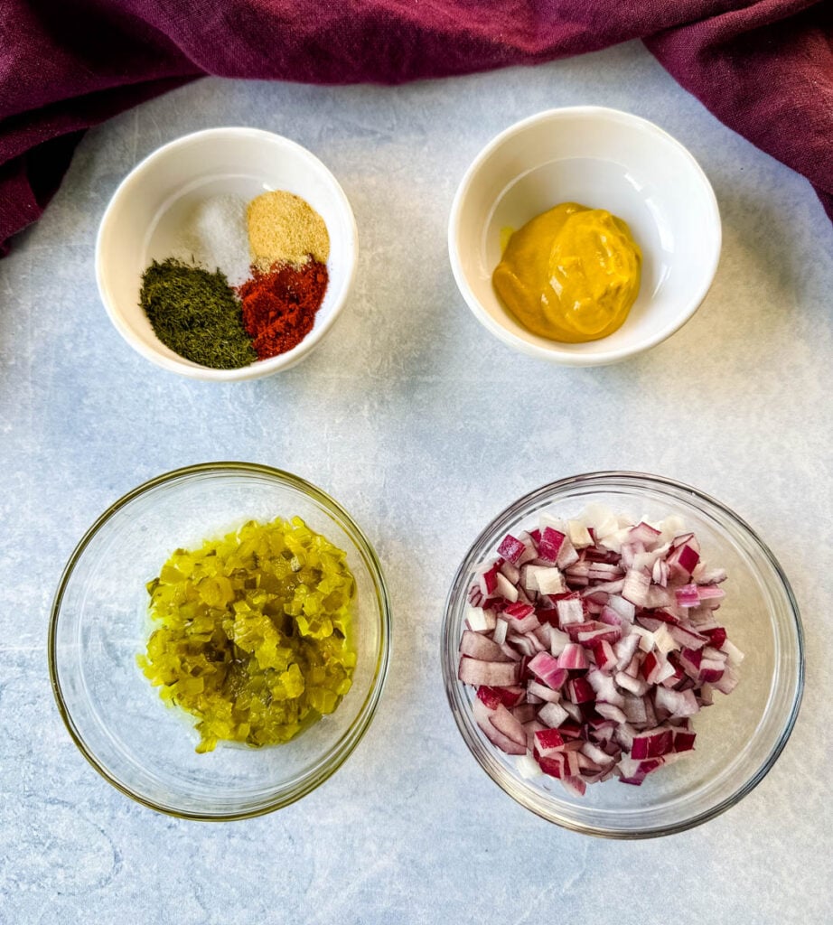 ranch seasoning, paprika, mustard, relish, and onions in separate white bowls