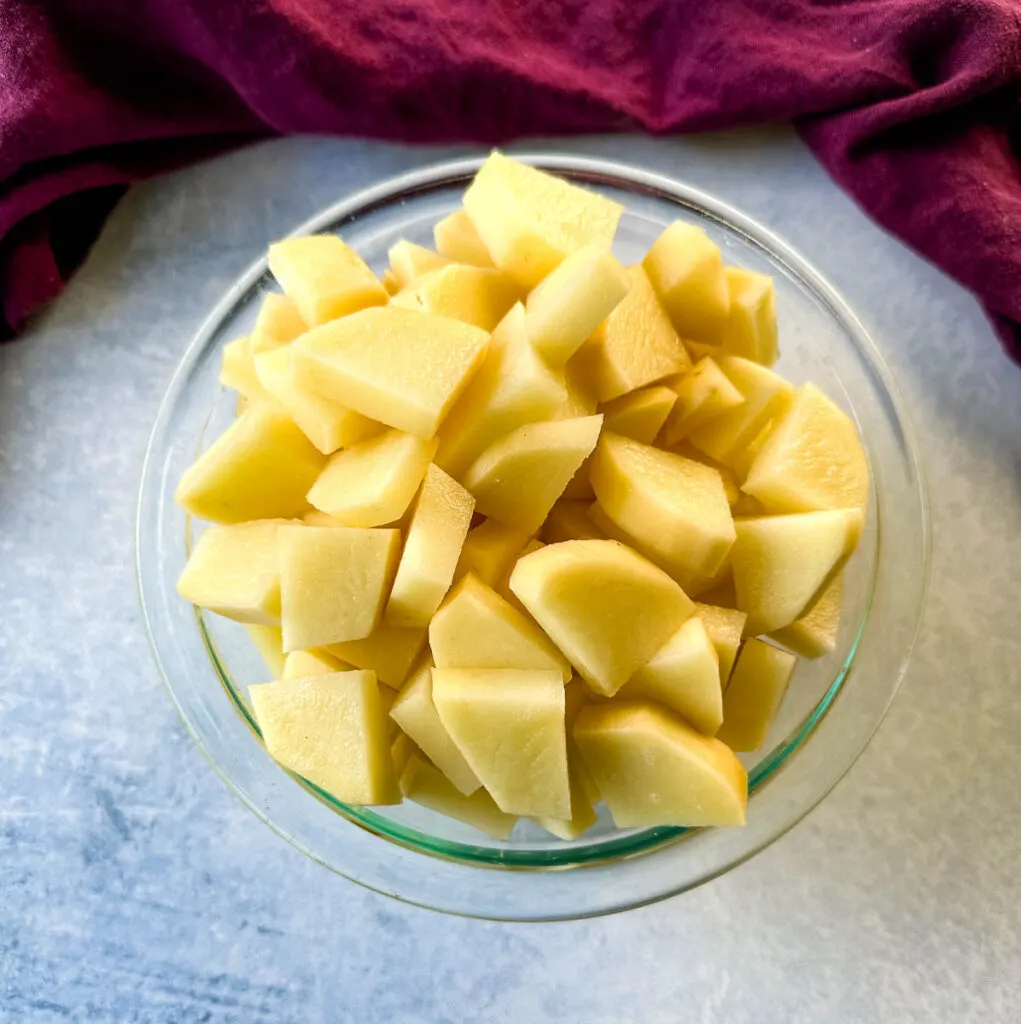 raw diced potatoes in a glass bowl