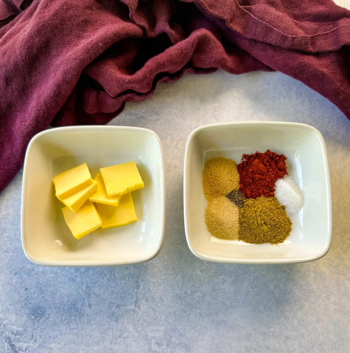 butter and spices in separate white bowls