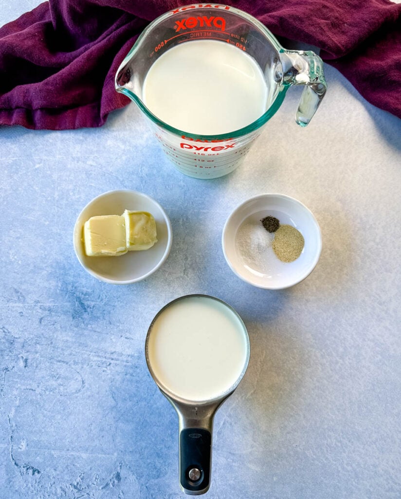 milk, butter, garlic powder, salt, pepper, and heavy whipping cream in separate bowls