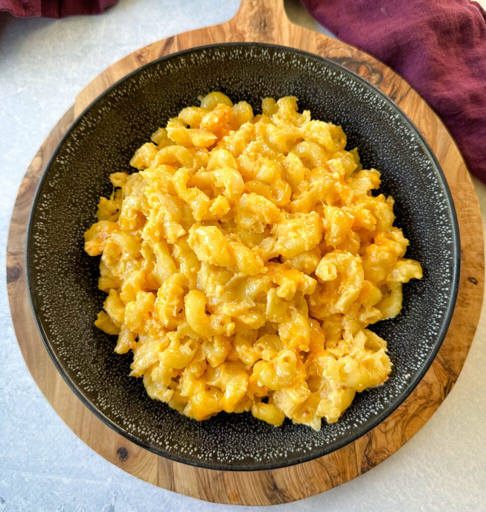 slow cooker Crockpot mac and cheese in a black bowl