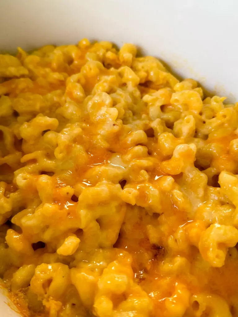 mac and cheese in a white Crockpot slow cooker