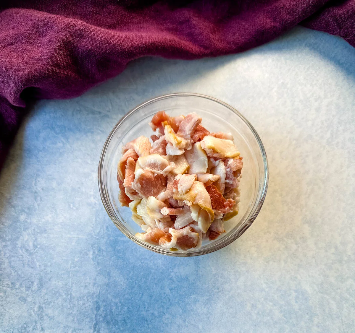 uncooked chopped bacon in a glass bowl