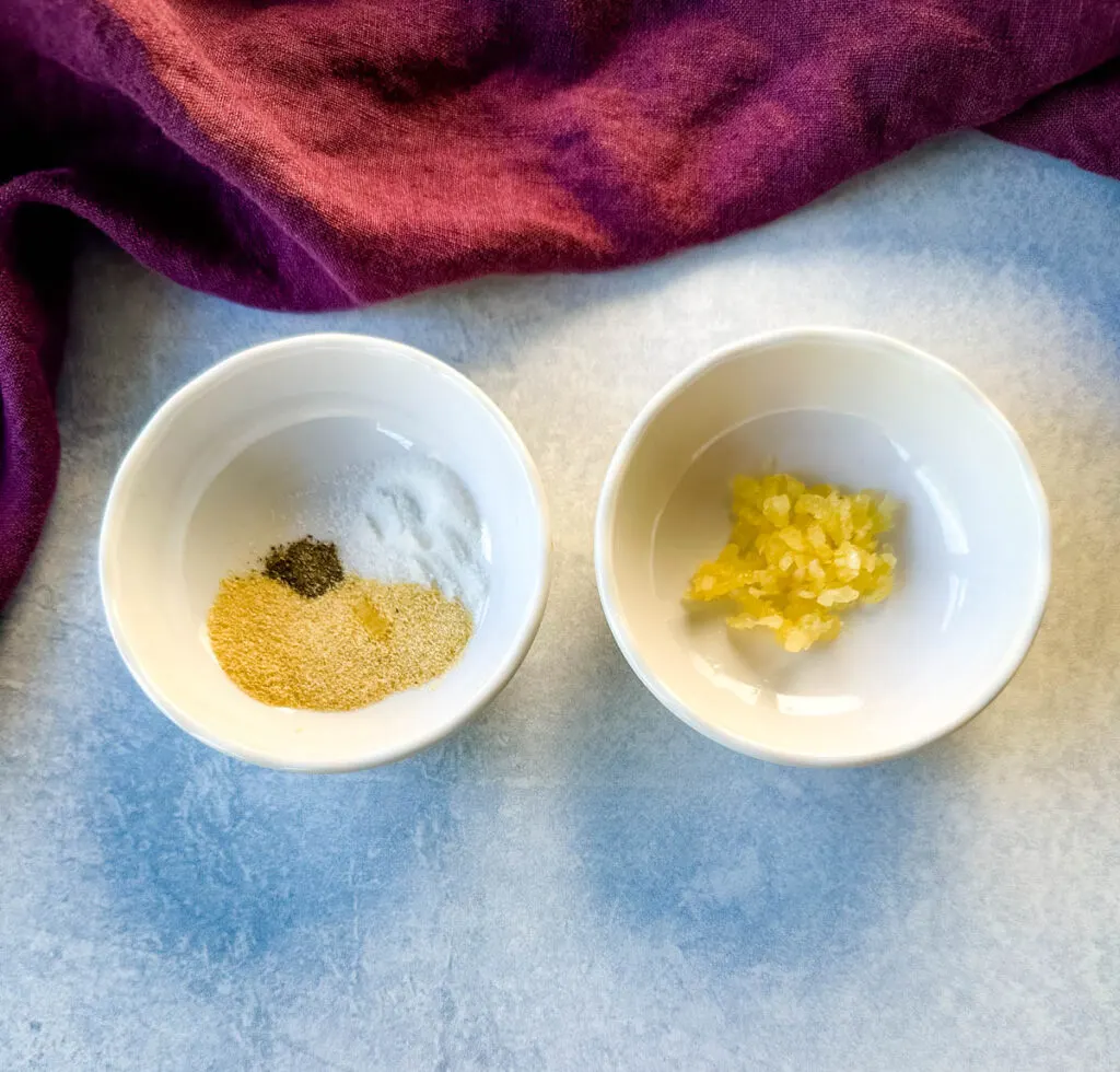 minced garlic and spices in separate white bowls