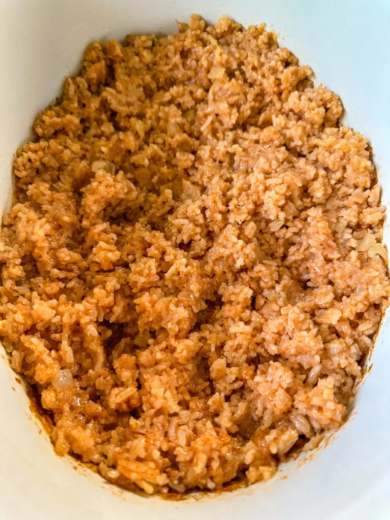 cooked Spanish Mexican rice in a white slow cooker Crockpot