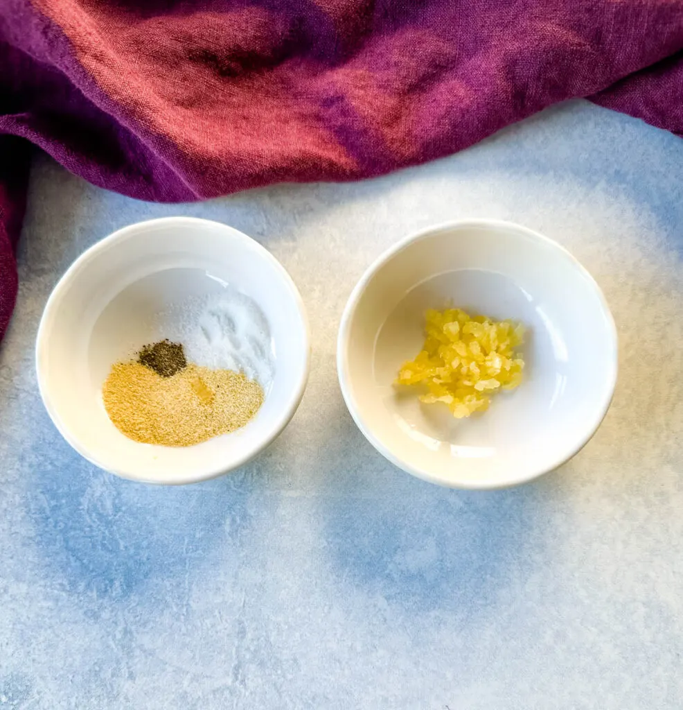 minced garlic and spices in separate white bowls