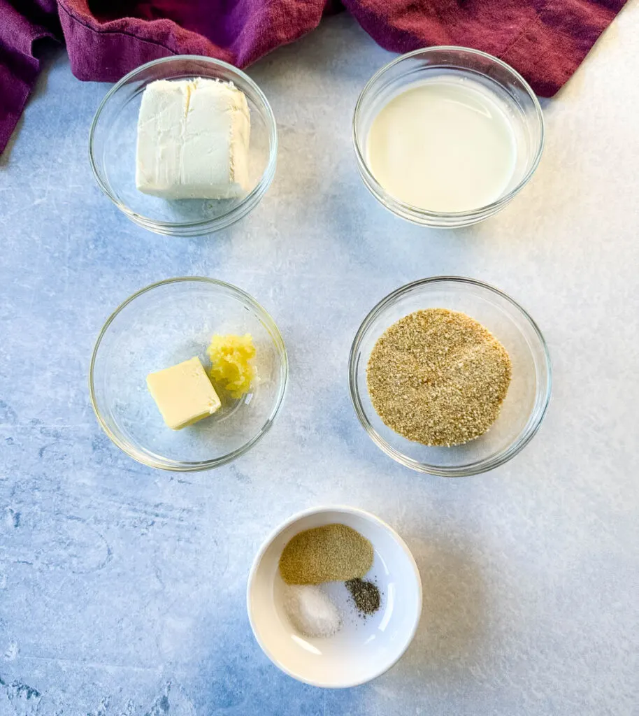 cream cheese, heavy cream, butter, breadcrumbs, and spices in separate glass bowls