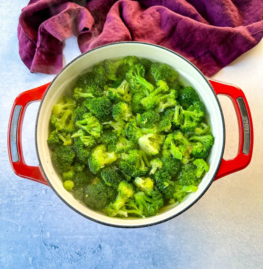 blanched broccoli in a Dutch oven with water