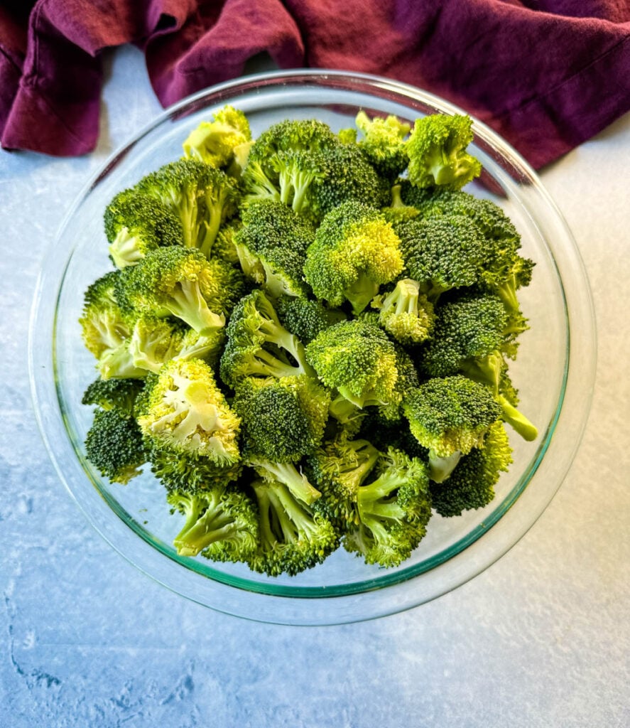 fresh broccoli florets in a glass bowl