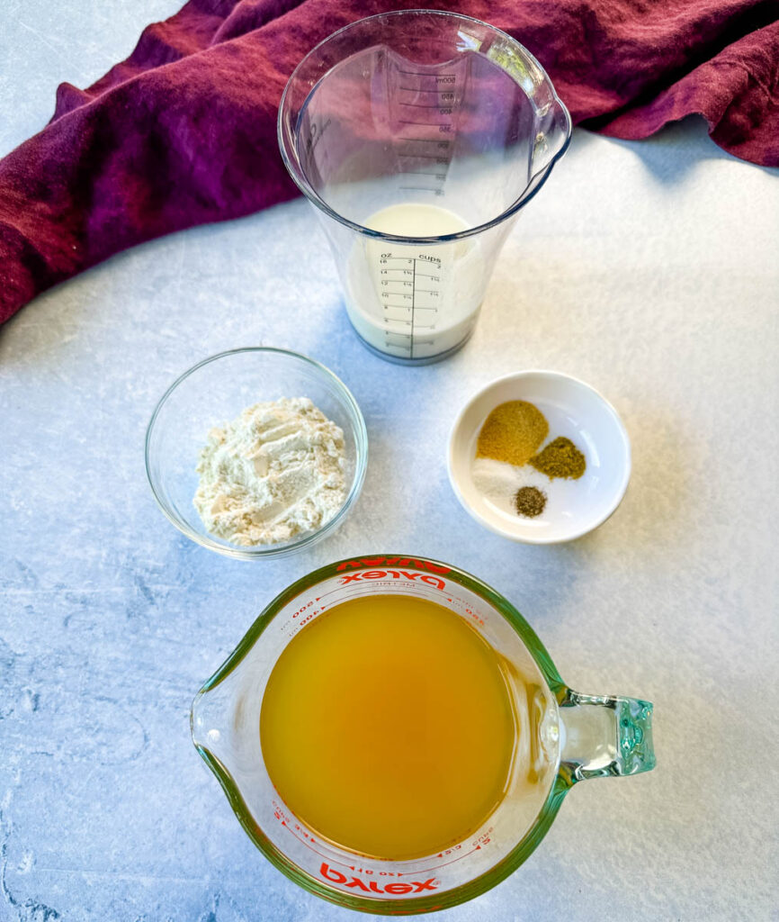 broth, flour, onion powder, garlic powder, poultry seasoning, salt pepper, and milk in separate glass bowls