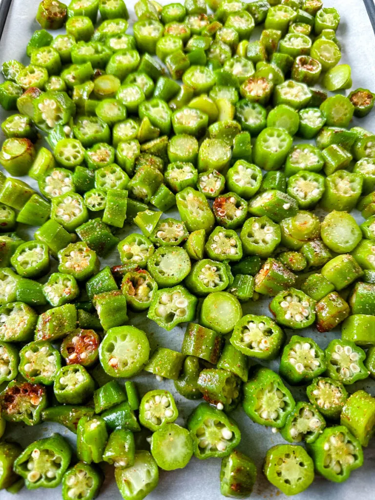 fresh okra on a sheet pan with spices