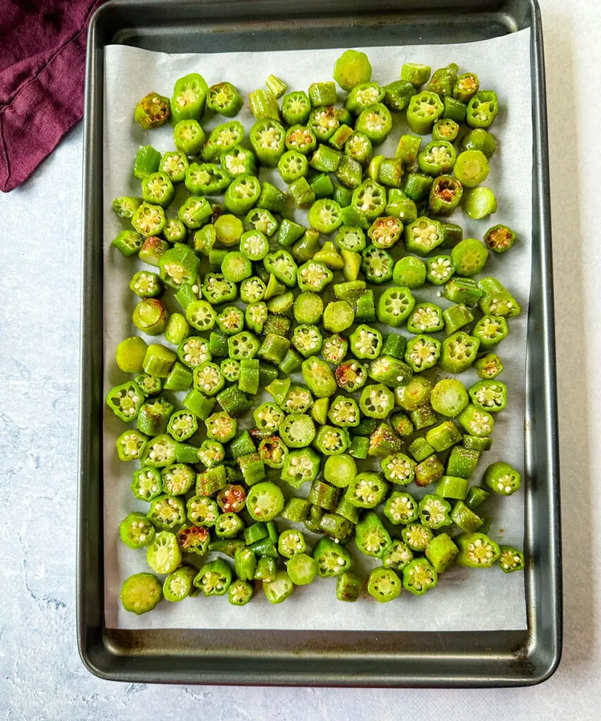 fresh okra on a sheet pan with spices