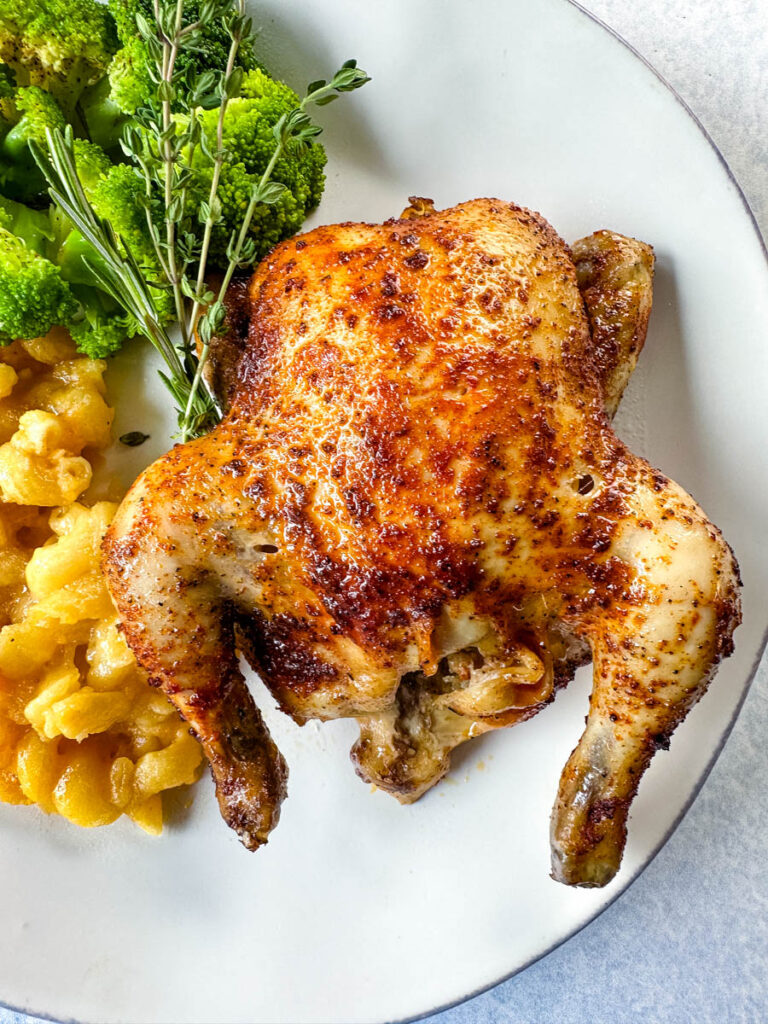 slow cooker Crockpot cornish hen on a plate with mac and cheese and brocooli