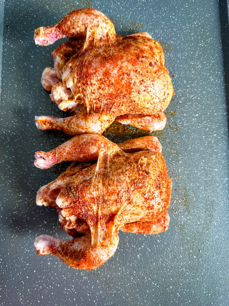 raw seasoned Cornish hens drizzled with olive oil