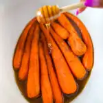 maple syrup drizzled over carrots in a Crockpot slow cooker
