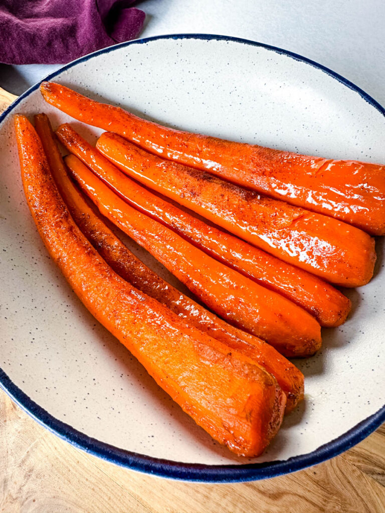 slow cooker Crockpot glazed carrots in a white bowl