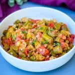 southern style stewed okra, tomatoes, and bacon in a white bowl.