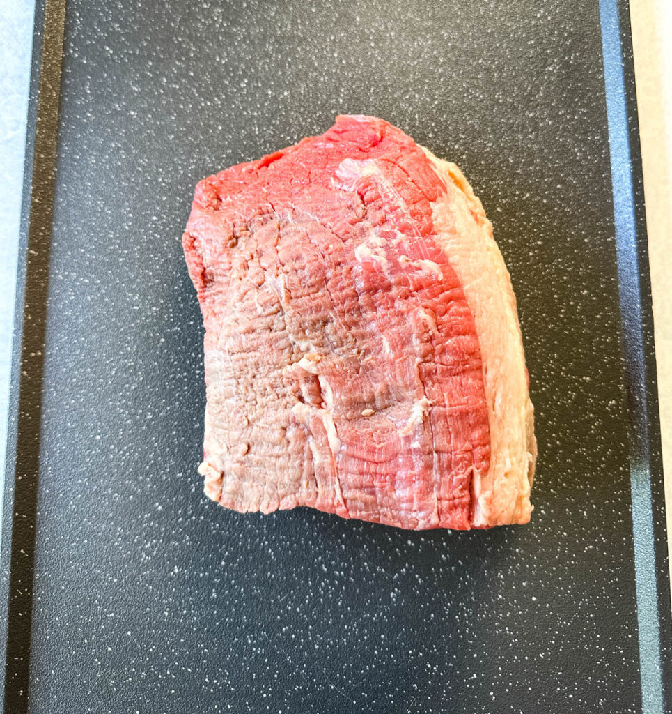 raw roast beef on a sheet pan