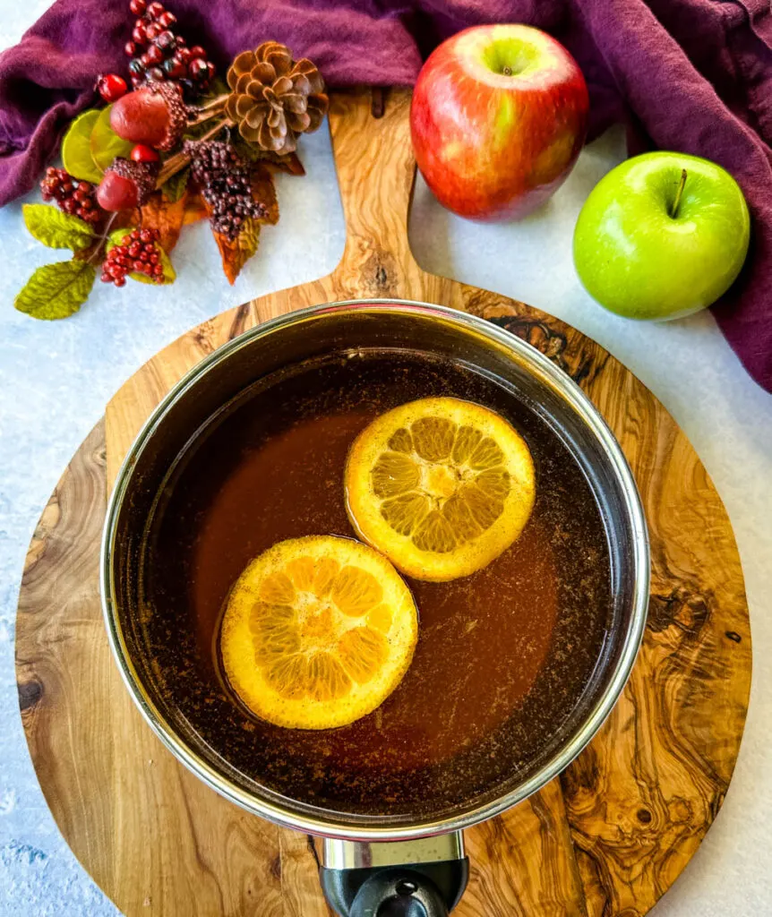 bourbon, apple cider, fresh oranges, and cinnamon in a saucepan