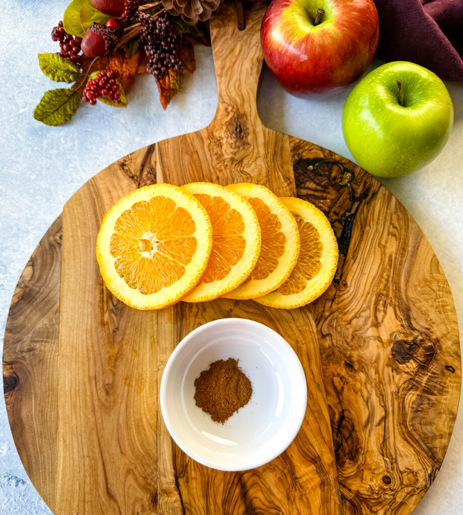 orange slices and cinnamon on a flat surface