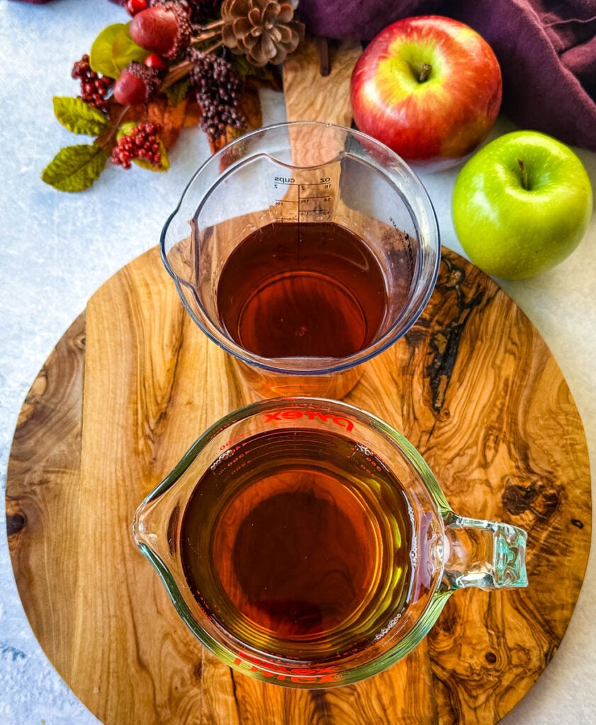 apple cider and bourbon in separate glass cups