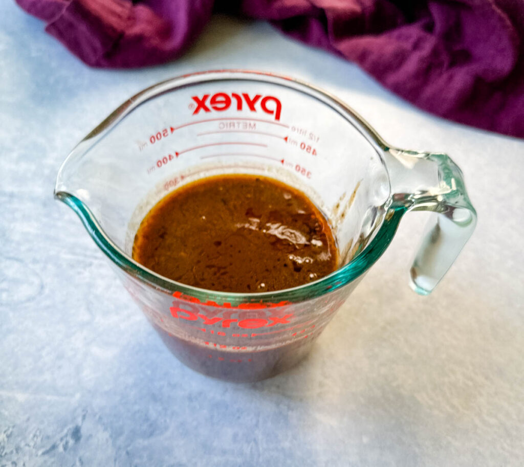 prime rib au jus gravy in a glass measuring cup