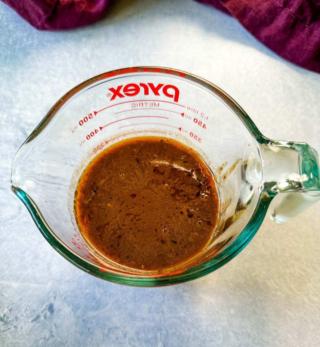 prime rib au jus gravy in a glass measuring cup