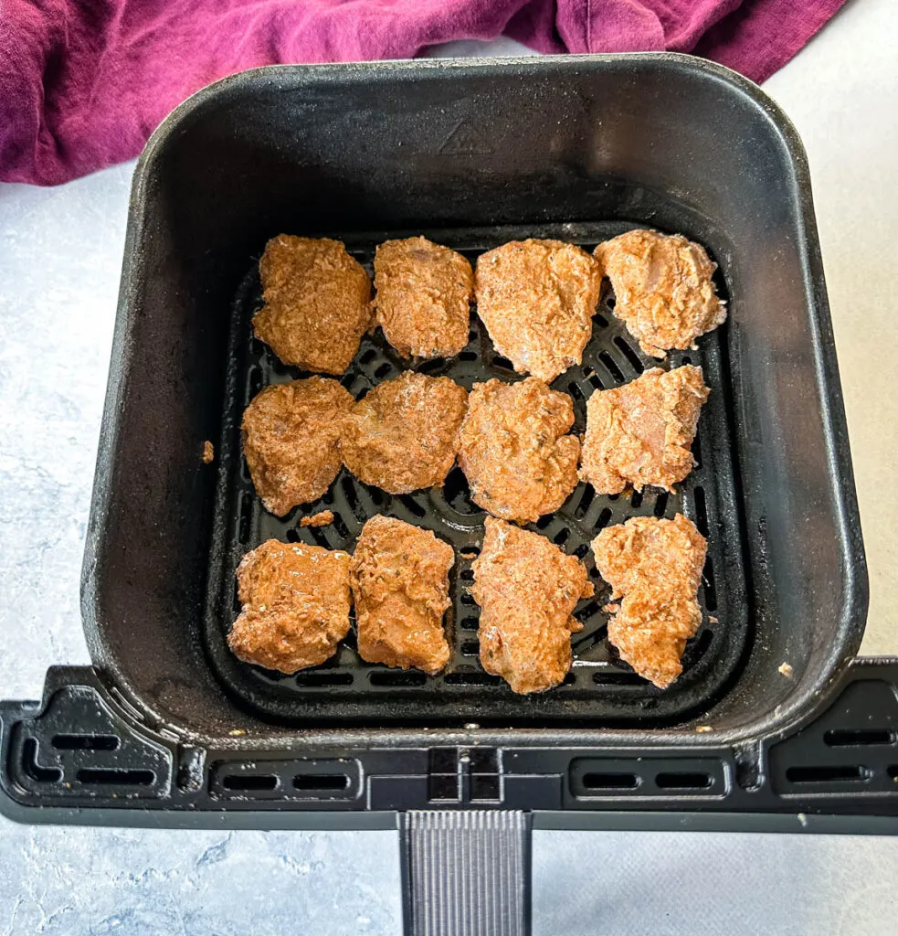 uncooked chicken tenders in an air fryer